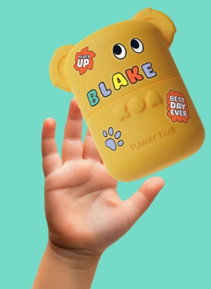 Hand reaching for a decorated KOA Tummy Time jar