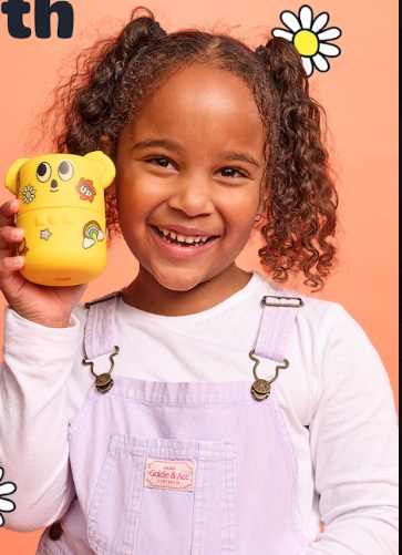 Child holding a sticker-decorated KOA Tummy Time jar